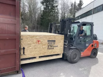 Large vault door in a wooden carton box